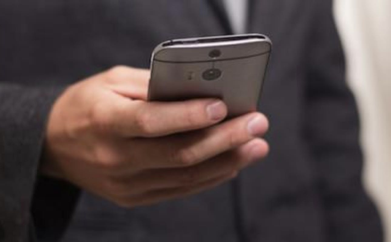 66fdb9ac01d3bff9f2af6c21 Mantextingusingsmartphone