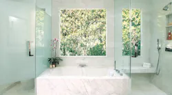 In a bath by Los Angeles-based Arch-Interiors Design group, the toilet is partially concealed, and there's abundant daylight (Photo: Courtesy Arch-Interiors)