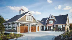 No synthetic products were used on the exterior of this coastal Michigan custom home, only natural wood, stone, and copper. The home nestles into its wooded setting near the lake. Photo: Ashley Avila Photography
