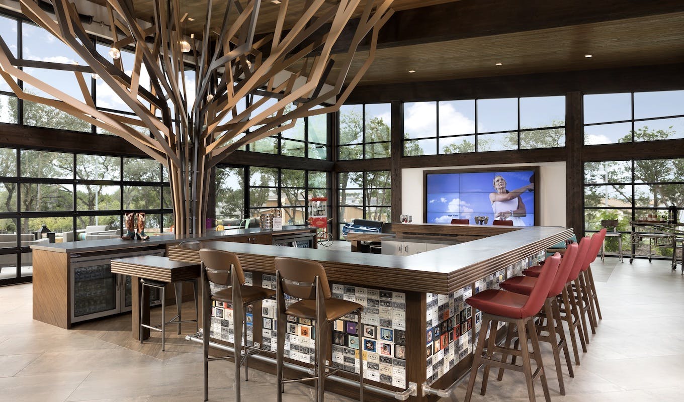 66fdba15de5fd15f7e547f2e Kissingtreewelcomecentercentralbarwithseatingtrees