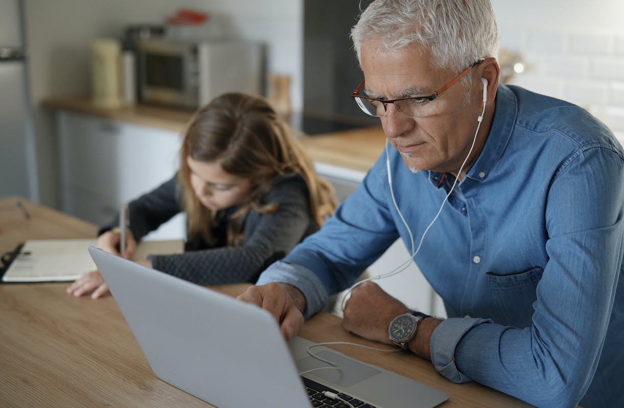 66fdba1ddbd68e31554a9ba1 Manworkinglaptopinkitchenwithearphoneswhilegirlwri