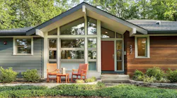 Architect Nathan Kipnis and builder Tiedmann Enterprises in Illinois used fiber-cement clapboard siding and ipe wood slats to highlight this Lake Bluff home’s entry, provide visual interest, and break up mass. | Photo: courtesy Nathan Kipnis 2021