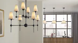 The eight-light chandelier in Gunmetal (foreground) in Kohler's Parohn lighting collection offers classic but modern styling. (Parohn one-light pendants shown in background.) | Photo: courtesy Kohler
