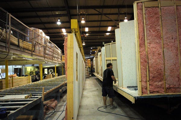 66fdbe62de5fd10ea5548b32 Manufactured Home Side Walls Are Built And Attache