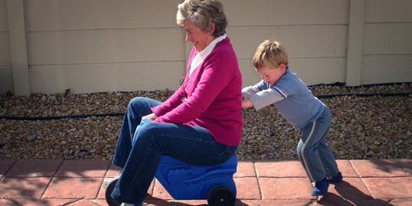 66fdbe8bdbd68e11f44aa79b Child Pushing Grandmother On Plastic Tricycle