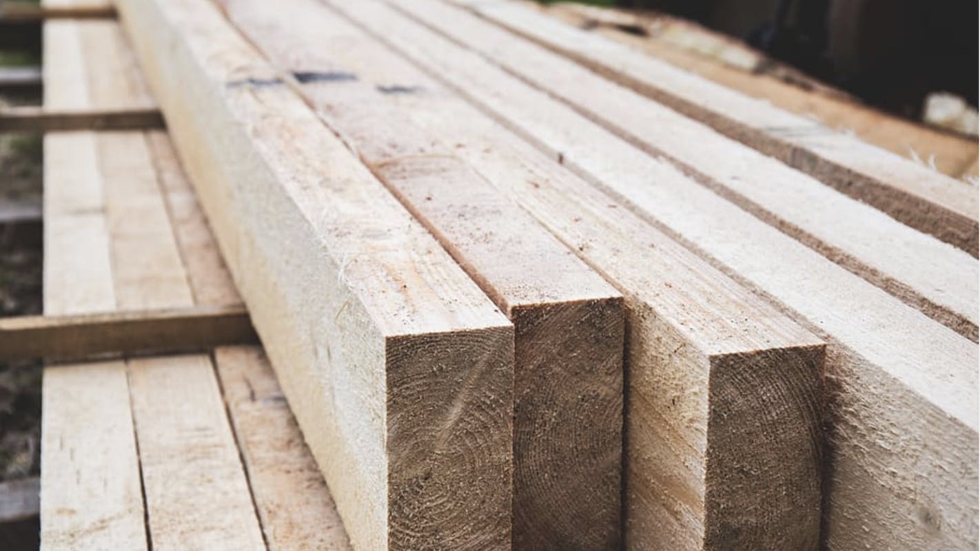 66fdc07adbd68e27634aad33 Lumberstackedreadyforhomebuilding