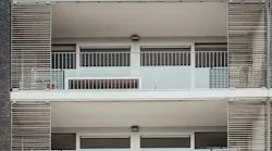 Government regulations add layers of compliance costs for multifamily housing builders. (Photo: Unsplash/Bernard Hermant)