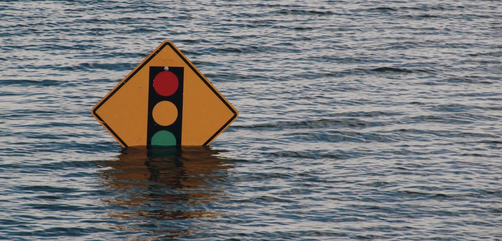 66fdc57dd4ea38ec27a5a561 Floodwatersrisingovertrafficsign
