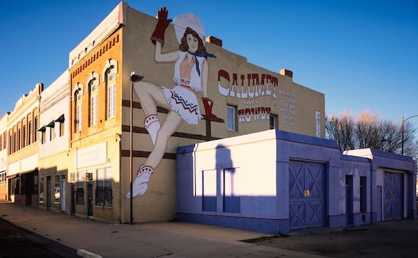 66fdc5b3a897b55944b20a07 Cow Girl On Building