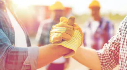 close up of builders hands making handshake By Syda Productions - Adobe Stock
