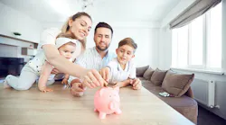 Happy family at the table in the room. By Studio Romantic - Adobe Stock