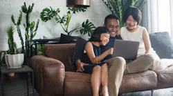 Happy Asian family using the computer together at home. By bearinmind - Adobe Stock