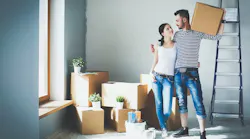 Happy young couple unpacking or packing boxes and moving into a new home By lenets_tan - Adobe Stock