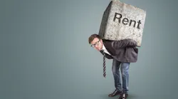Conceptual image of a man burdened by high rent By photoschmidt -Adobe Stock
