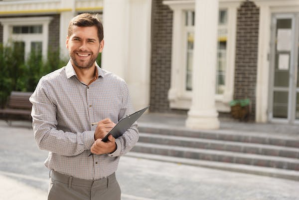 66fdc663de5fd1e4db54991d Smilingrealtorinfrontofhome