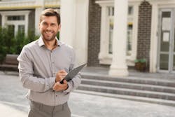 66fdc663de5fd1e4db54991d Smilingrealtorinfrontofhome 66fdc663de5fd1e4db54991d Smilingrealtorinfrontofhome