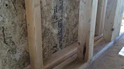 The home’s double 2x4 wall stud system, separated by a 2 1/2-inch air space, will be insulated with blown fiberglass and air-sealed at the drywall, but will not have exterior insulation board. | Photo: Thrive Home Builders