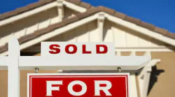 For sale sign in front of house