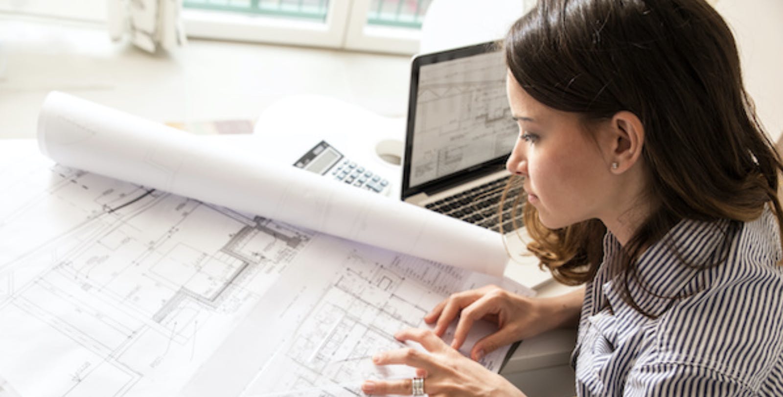 66fdc6b0de5fd171fb5499dd Architectlookingatblueprints