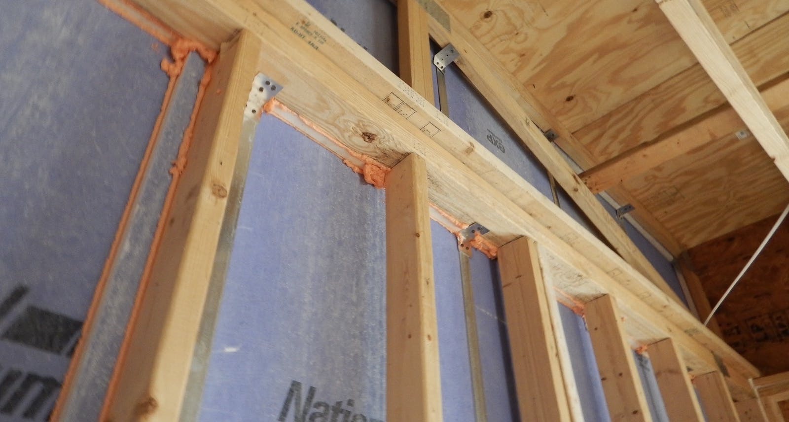 This party wall includes the best practices mentioned in this article: fiberglass-mat faced gypsum shaft liner, gypsum blocking in the gap between the liner and the wall top plate, and fire-rated foam. | All photos: courtesy IBACOS