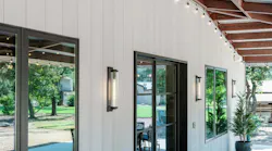 When replacing exotic hardwoods such as Ipe, one pallet of Acre saves an acre of tropical rainforest, according to the report. Pictured: The Austin Barn vertical siding using Acre sheets. Photo courtesy Modern Mill