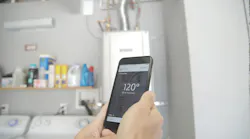 Noritz%20 Wifi%20 Adapter%20with%20hand%20holding%20smart%20phone