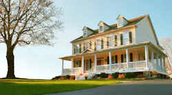 Traditional home exterior with a porch, pitched roof, and window shutters