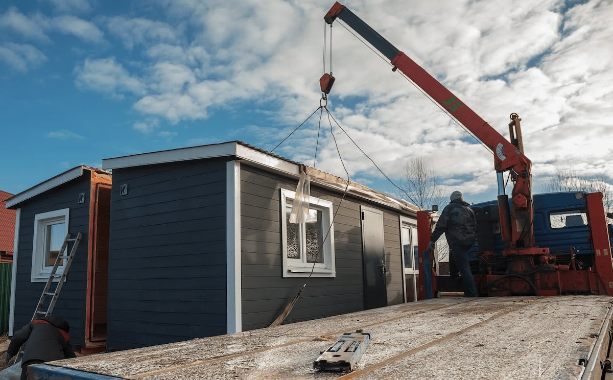Modular home being delivered to the jobsite by truck
