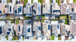 Aerial view of a row of single-family homes with solar panels on the roof