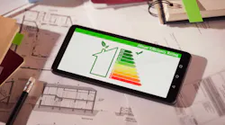 Energy-efficiency rating showing on tablet with house plans in background