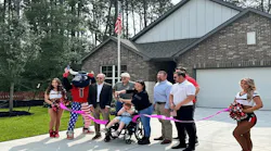 The Ellenbeck family, along with the development team and the Houston Texans, hold a welcoming ceremony in front of their newly built home.