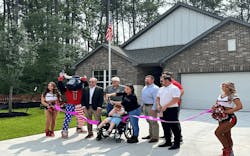 The Ellenbeck family, along with the development team and the Houston Texans, hold a welcoming ceremony in front of their newly built home. The Ellenbeck family, along with the development team and the Houston Texans, hold a welcoming ceremony in front of their newly built home.
