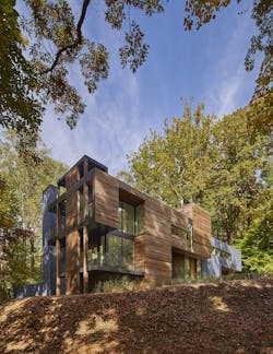Master bedroom with large windows and black linear fireplace Master bedroom with large windows and black linear fireplace