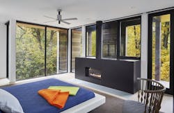Master bedroom with large windows and black linear fireplace Master bedroom with large windows and black linear fireplace