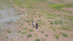 Sky_vie_of_two_people_standing_on_bulding_lot Sky_vie_of_two_people_standing_on_bulding_lot