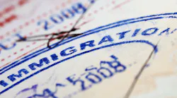 Blue immigration stamp on document