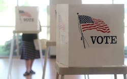 Voters cast their ballots at voting booths in US elections. Voters cast their ballots at voting booths in US elections.
