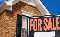 A 'For Sale' sign sits in the front yard of a brick single-family home A 'For Sale' sign sits in the front yard of a brick single-family home