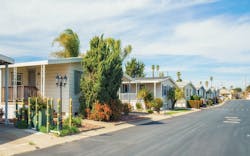 A row of manufactured houses on a suburban street A row of manufactured houses on a suburban street