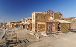Framing underway for single-family homes in a residential neighborhood under construction Framing underway for single-family homes in a residential neighborhood under construction