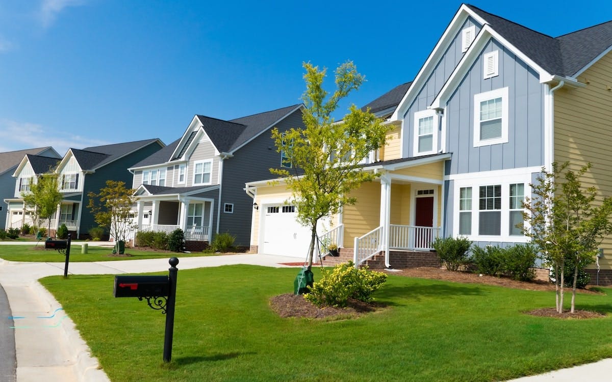 A row of new-construction homes in a residential neighborhood