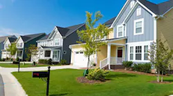A row of new-construction homes in a residential neighborhood