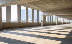 An empty parking garage overlooking a city An empty parking garage overlooking a city