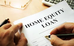A homeowner signs a home equity loan A homeowner signs a home equity loan