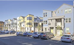 street view of exterior infill housing development Nova at the Vale, yellow-blue-gray color scheme street view of exterior infill housing development Nova at the Vale, yellow-blue-gray color scheme