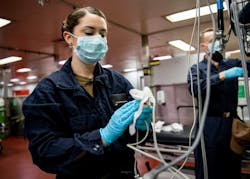 woman wearing protective mask sanitizes medical equipment during coronavirus pandemic woman wearing protective mask sanitizes medical equipment during coronavirus pandemic
