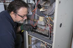 HVAC contractor working on installing home HVAC system HVAC contractor working on installing home HVAC system
