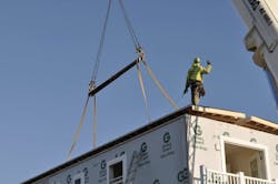 prefabricated roof panel being lowered into place on site by crane prefabricated roof panel being lowered into place on site by crane