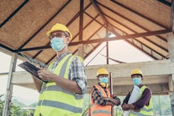 construction workers wearing protective masks against COVID-19 construction workers wearing protective masks against COVID-19