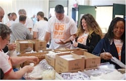 True Homes volunteers pack boxes for the homeless True Homes volunteers pack boxes for the homeless